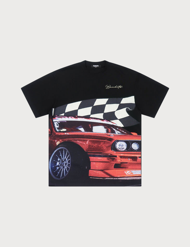S TEE BLACK is an oversized embroidered black t-shirt made from heavy GSM cotton, showcasing a large DTG-printed red sports car graphic with bold white stripes and a cursive signature near the neckline.